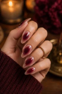 7. Burgundy Aura Center Nails